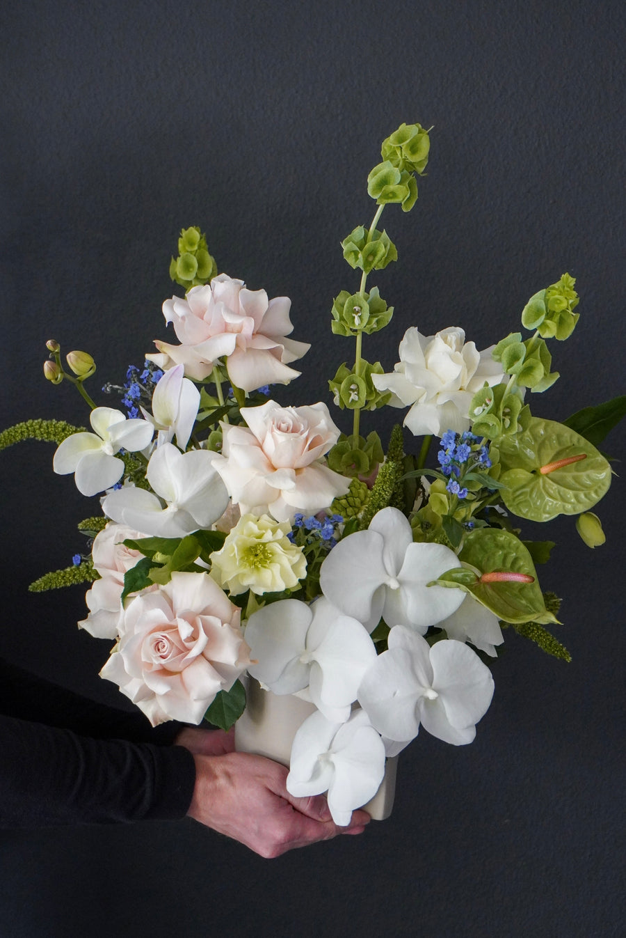 Vase arrangement Flora - orchids, anthuriums, roses, molucella